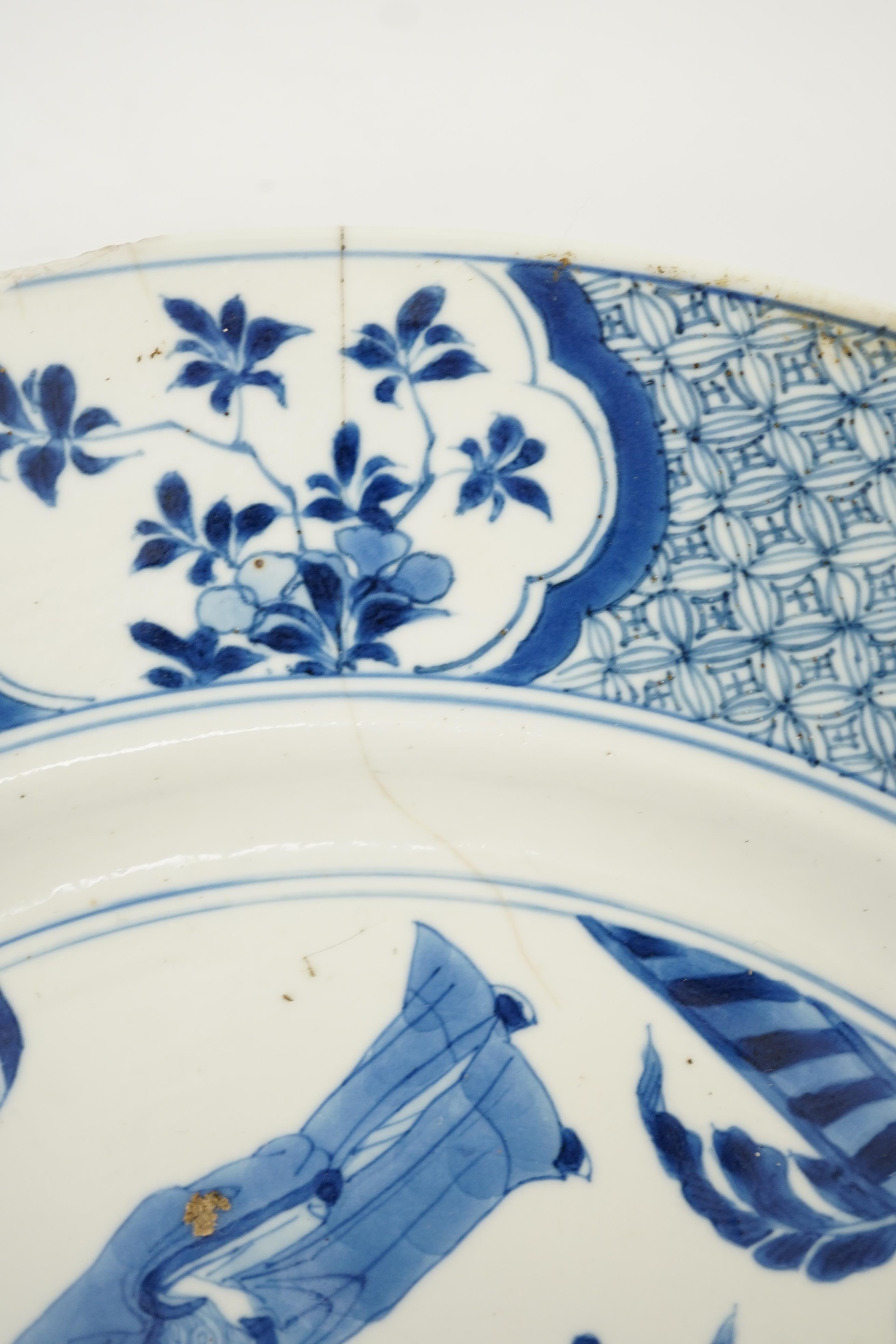 A Chinese blue and white ‘court scene’ dish, Kangxi period, two rim cracks and small splinter chips